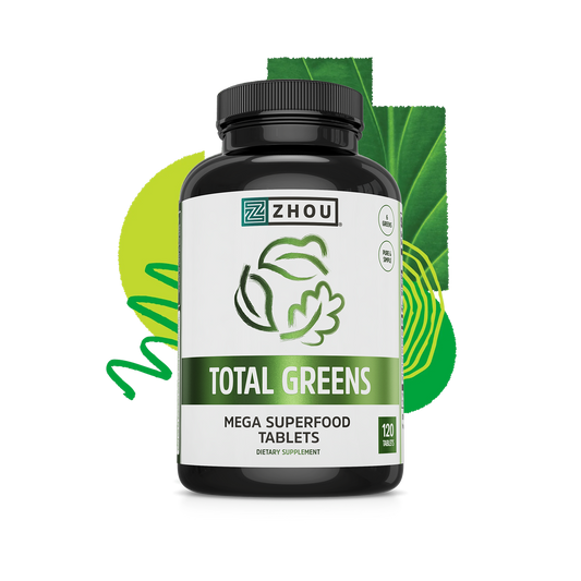 A bottle of Zhou Nutrition Total Greens, a spirulina supplement, with leafy label and green background.